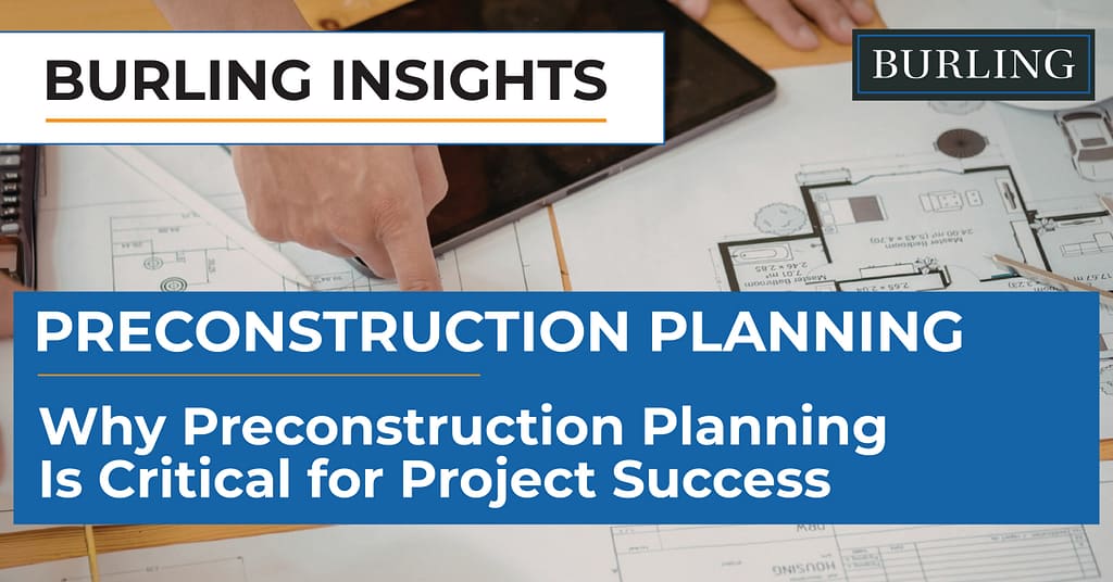 Close-up of a project team member pointing at architectural floor plans spread across a desk with a calculator and tablet, reviewing construction drawings and measurements.